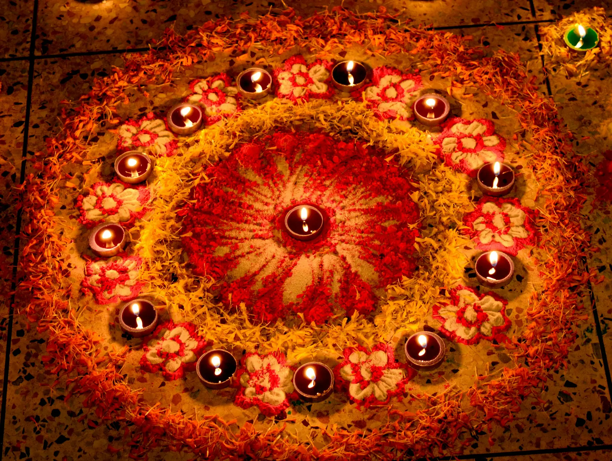 Rangoli of marigold petals and lit diyas