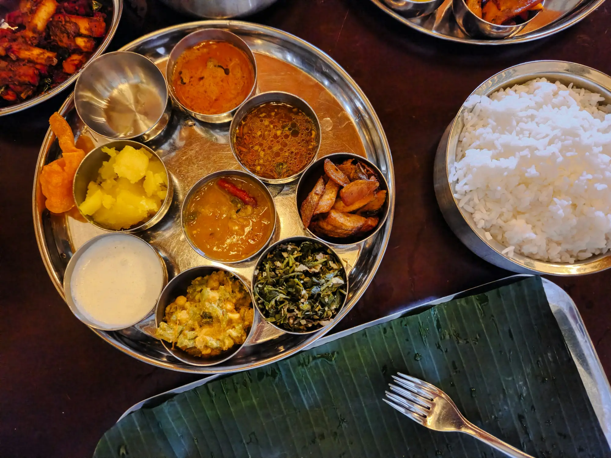 Silver thali with an array of Indian curries