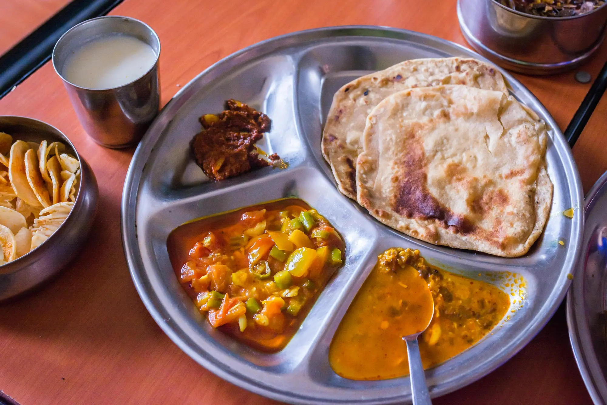 Indian thali with naan, paneer and dal