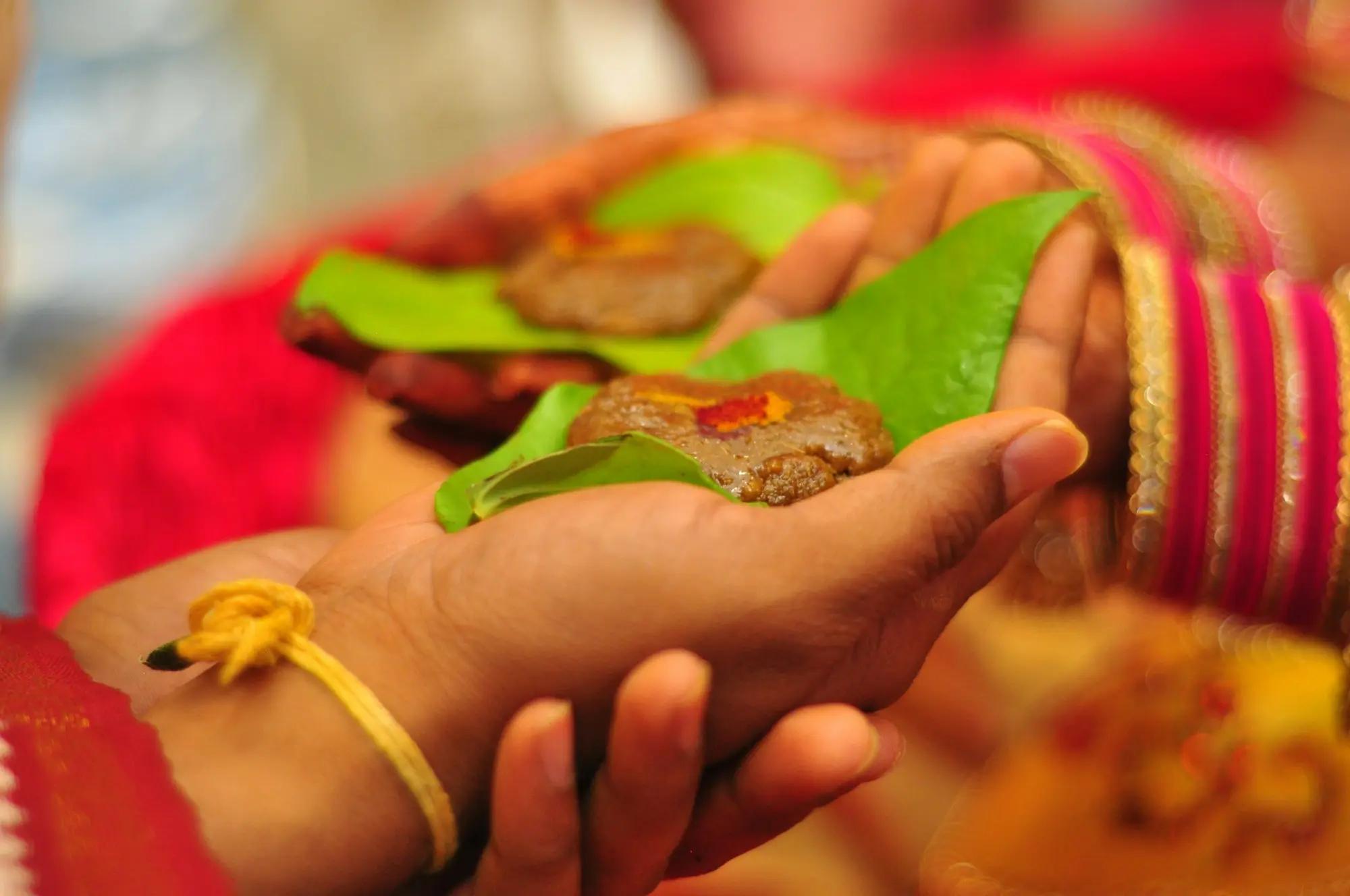 Traditional offering served on a leaf with bangled hands