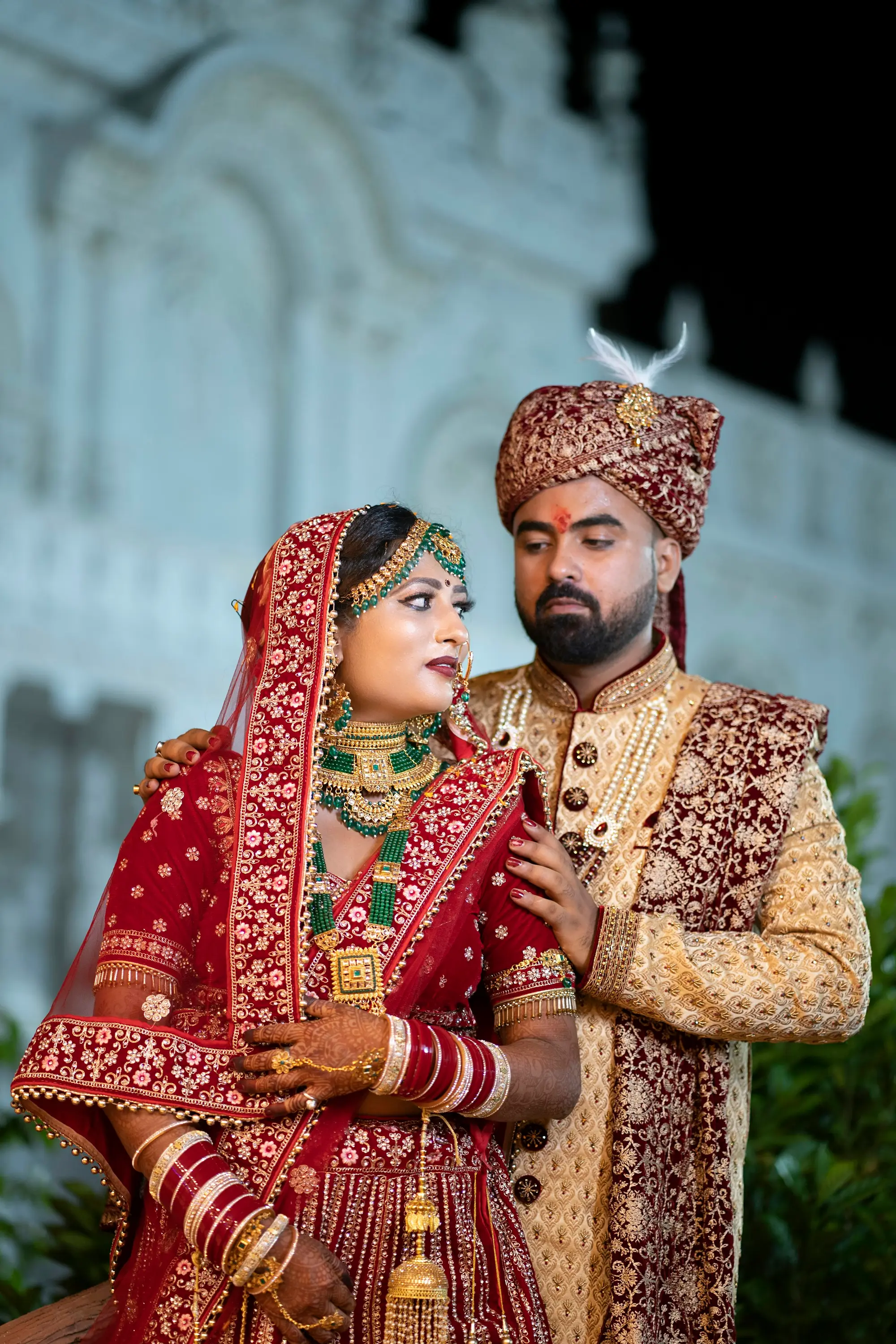 Indian couple in traditional wedding attire and safa