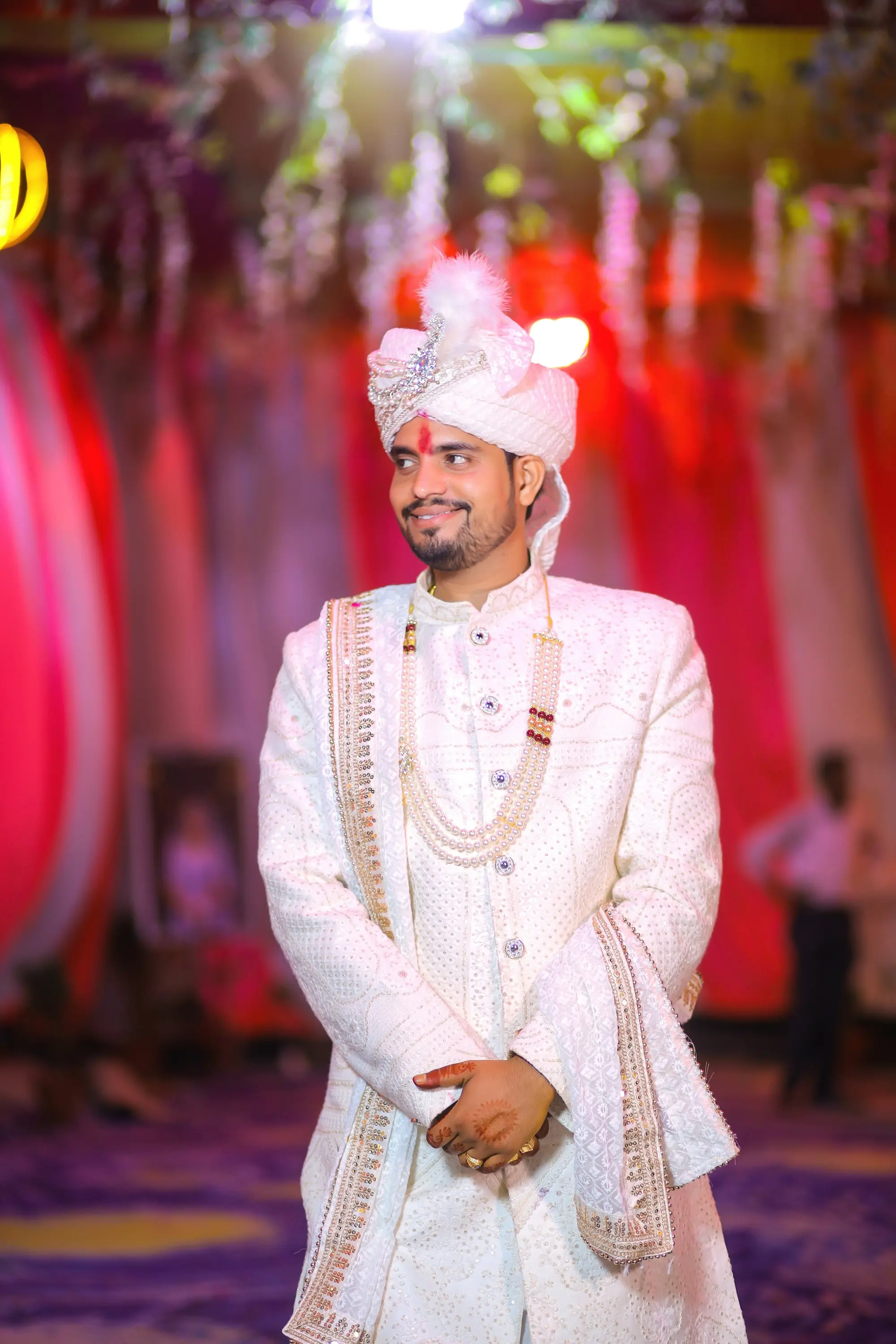 Indian groom in white sherwani and safa